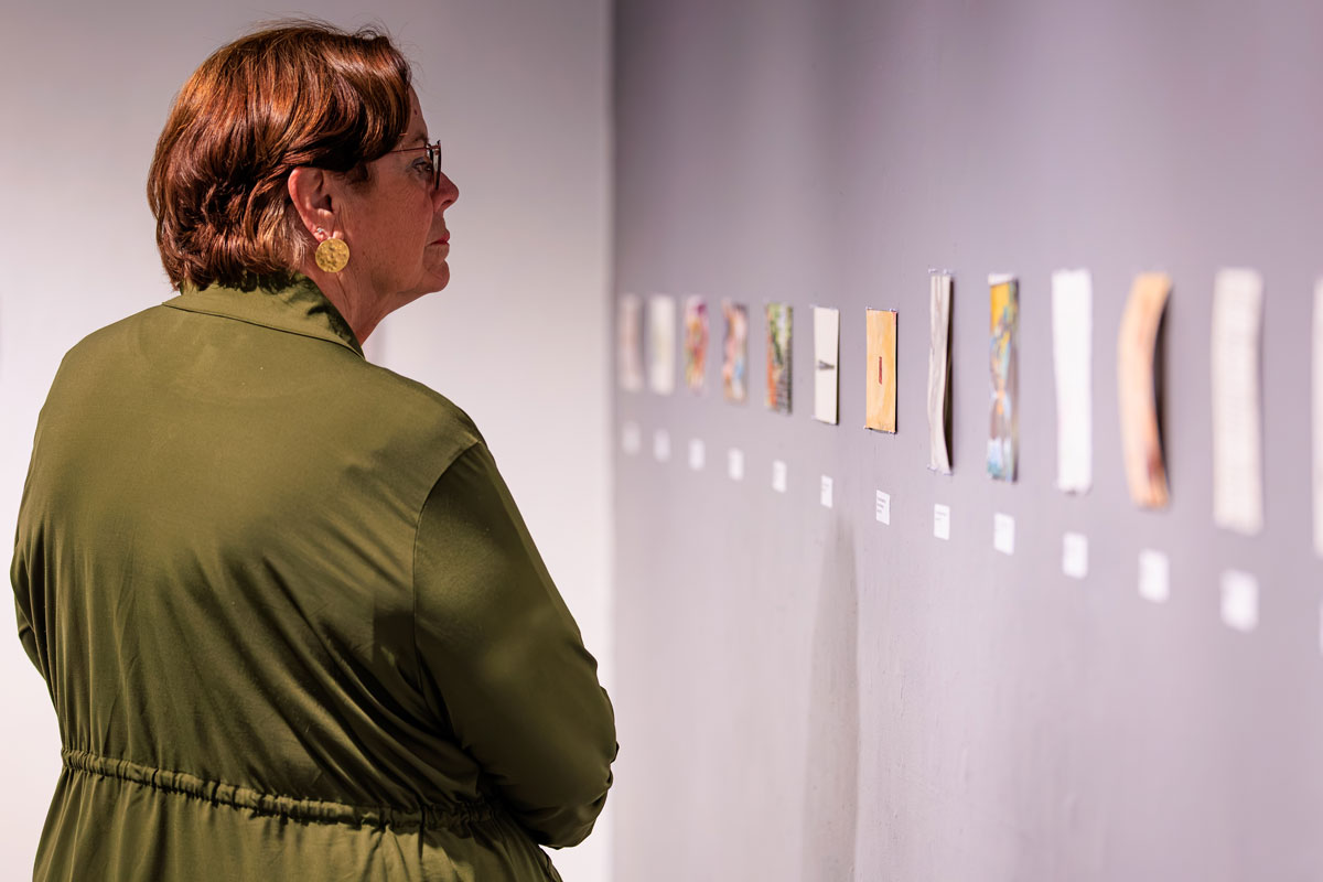 Someone looking at the IWU Art Alumni Exhibition