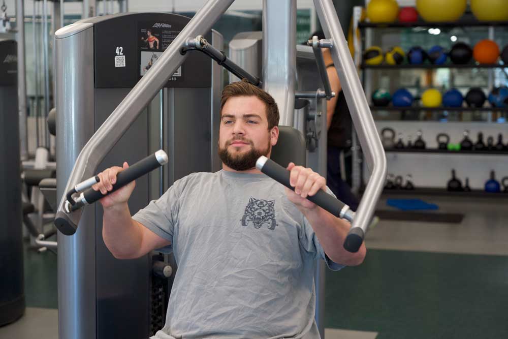 Male student working out in gym