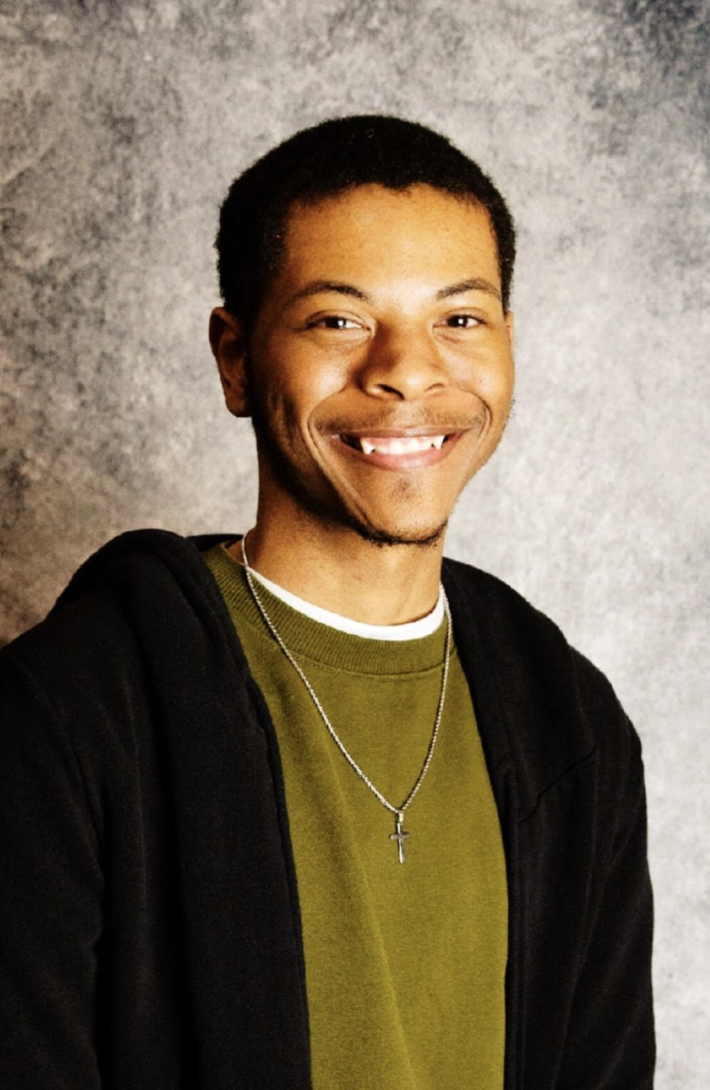 Male student smiling in a photo studio portrait