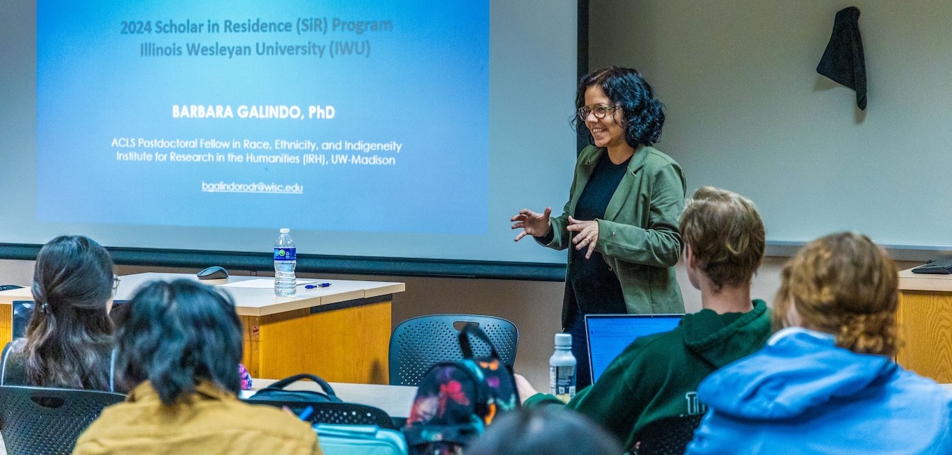 Barbara R. Galindo Rodrigues Marcos' Lecture Barbara R. Galindo Rodrigues Marcos speaking to classroom of students.