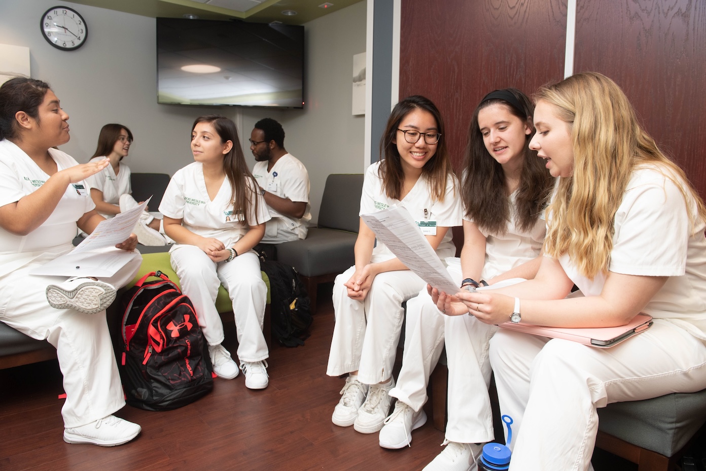 Nursing Class Nursing students sitting while discussing notes.